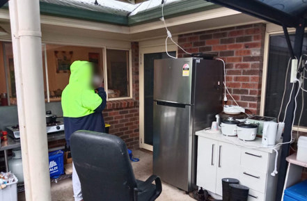 Unsafe, outdoor cooking facilities, with multiple electricity cords hanging from the roof to power appliances